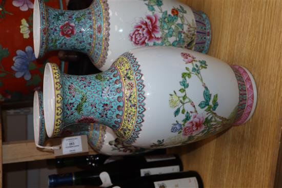 A pair of Chinese famille rose vases and another similar (3) Height 36cm